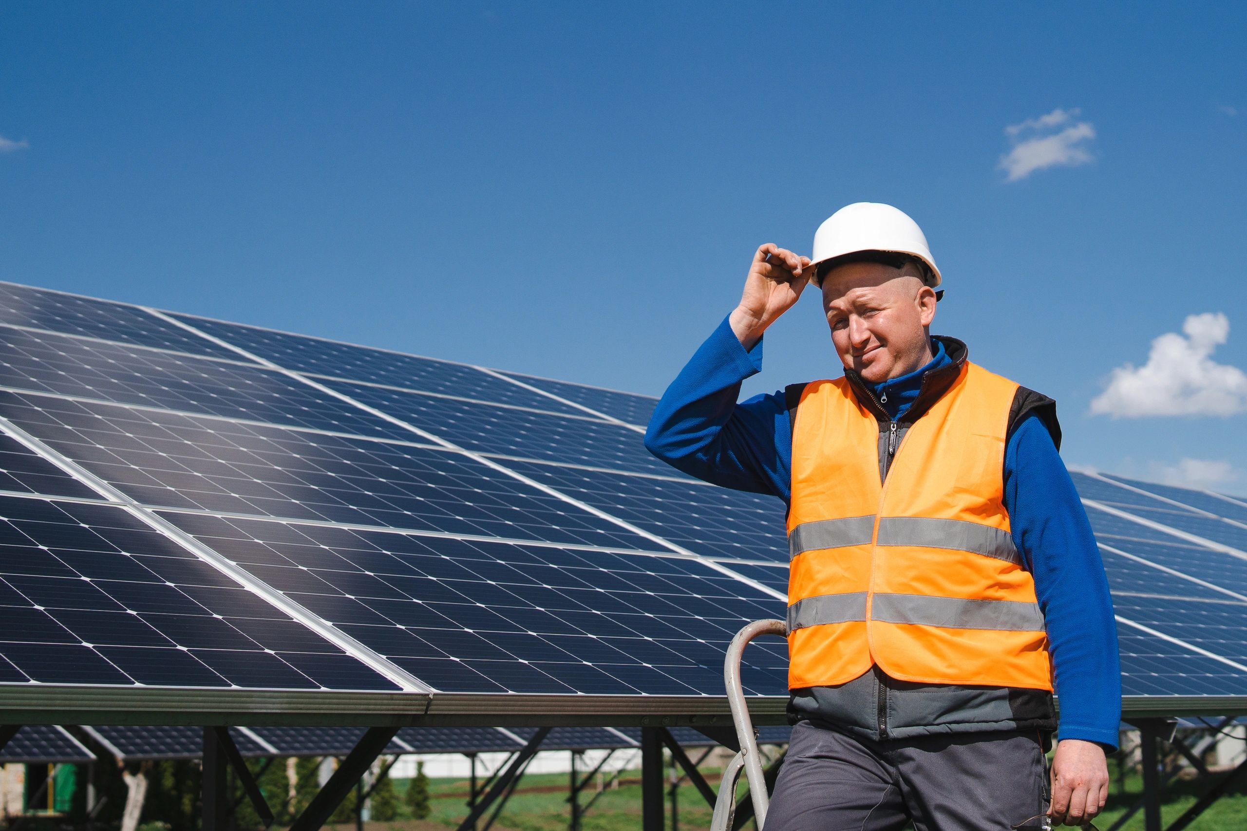 Technician standing beside solar panel installation