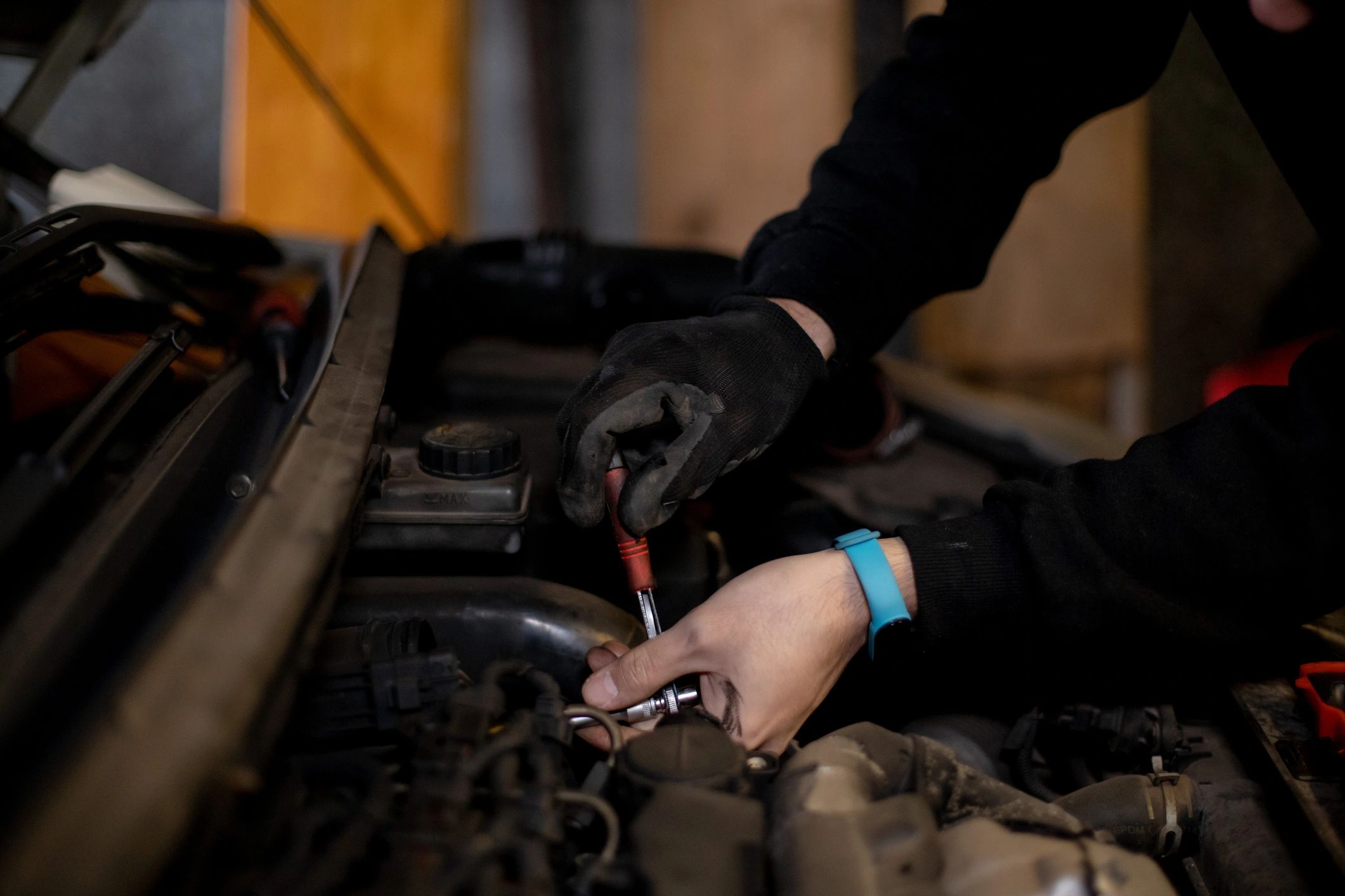 Mechanic performing car battery replacement