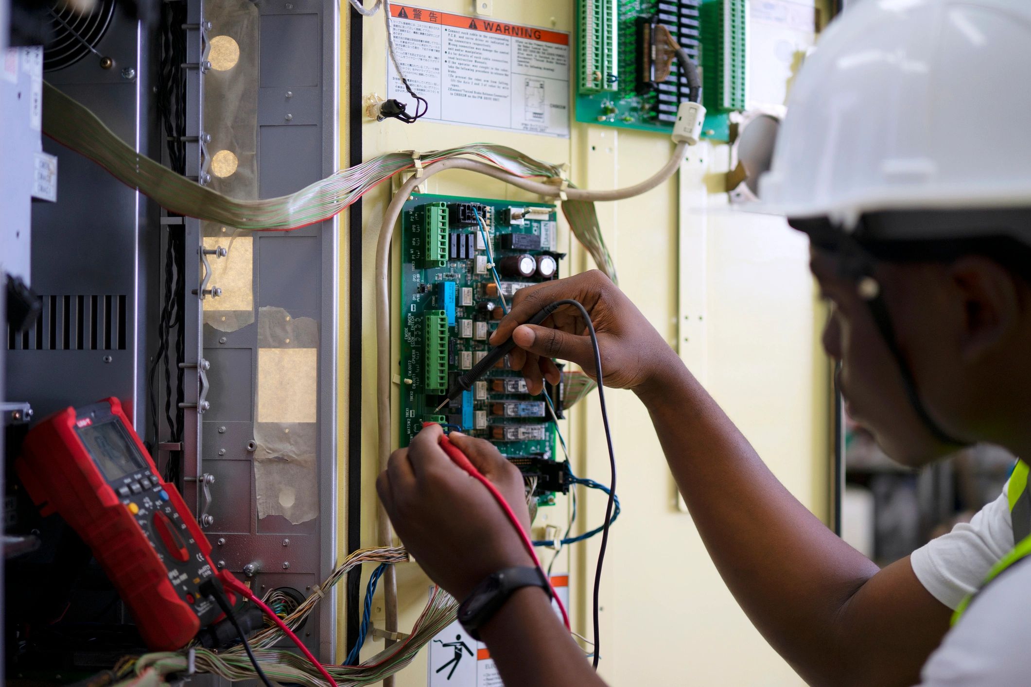 Technician servicing industrial electrical equipment