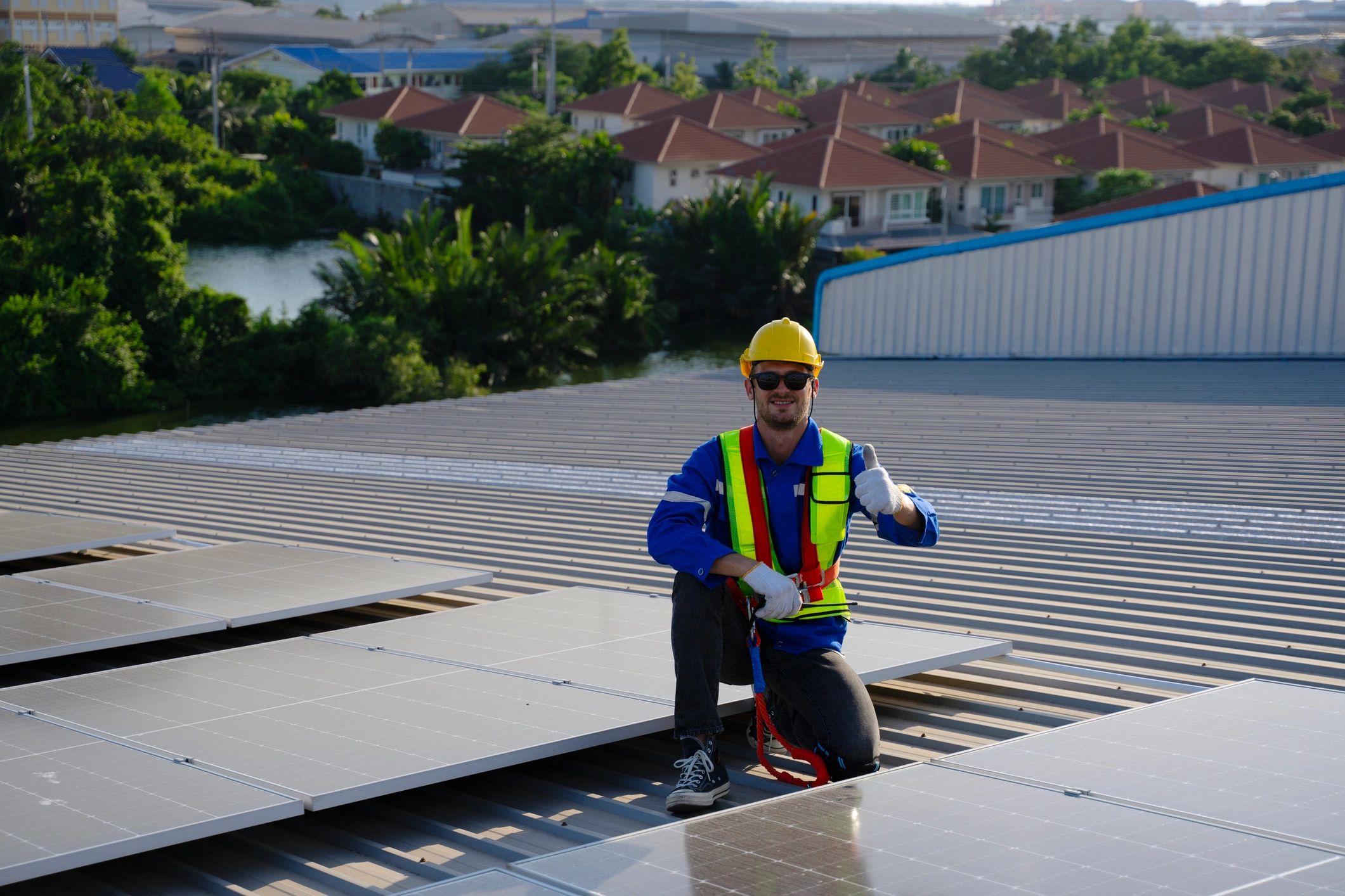 Technician working on rooftop solar panels